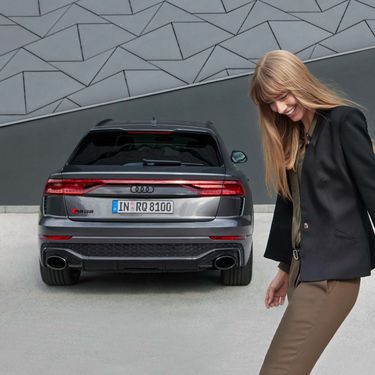Audi RS Q8 rear view with female model